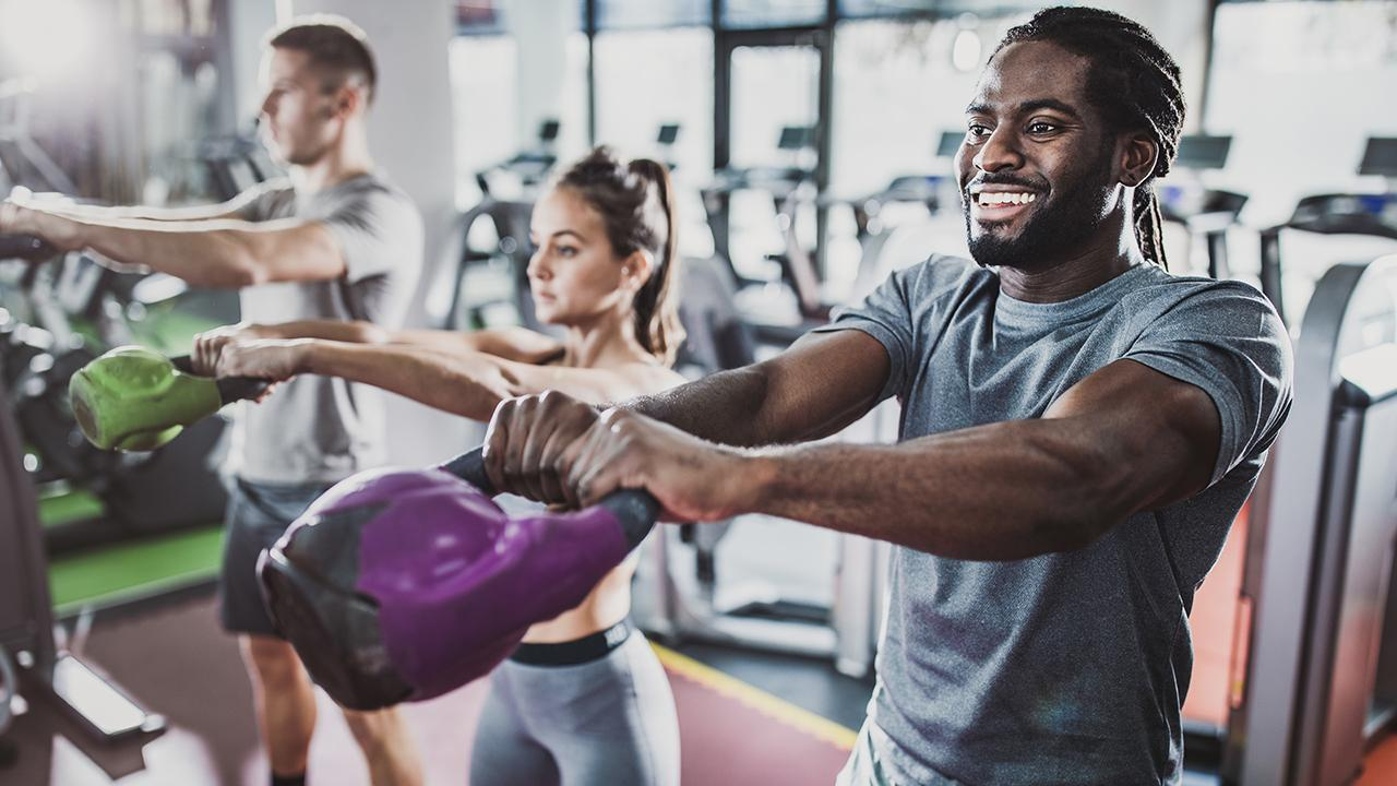people working out with kettle bells